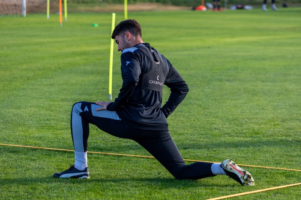 footballer stretching before a game