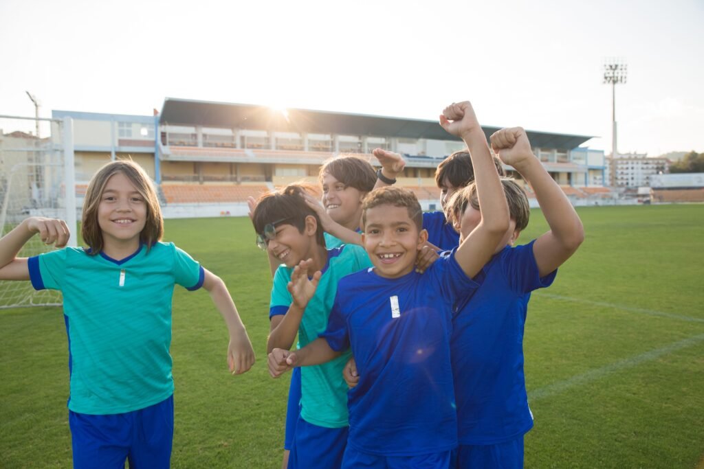 young footballers celebrating a goal