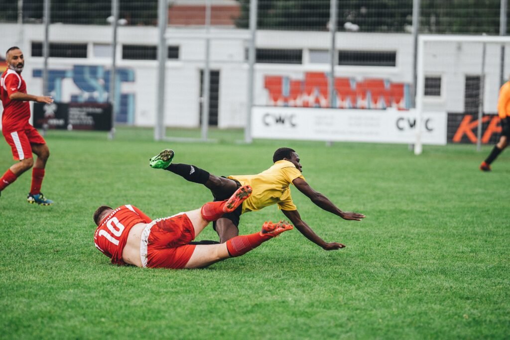 footballers collide into tackle
