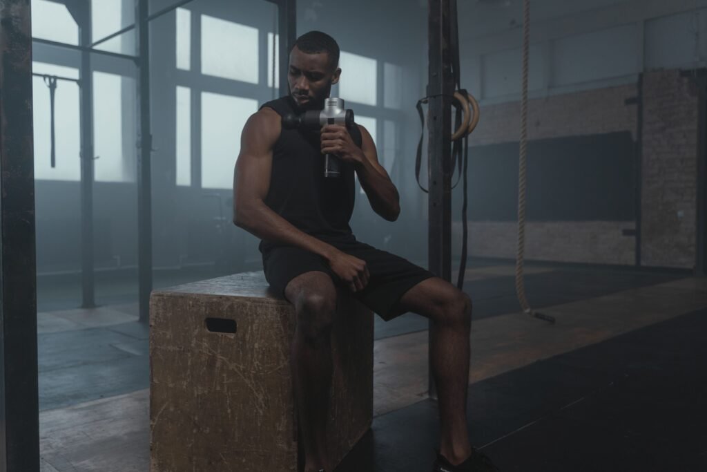 gym man using massage gun 